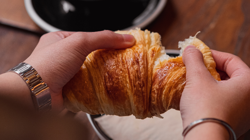 Person holding croissant