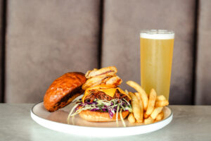 Father's Day brisket burger featuring slow-cooked beef brisket, cheese, crispy onions and slaw on a toasted milk bun.